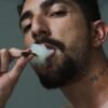 man smoking tobacco inside room