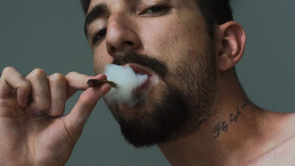 man smoking tobacco inside room