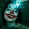 eerie joker smile behind wet glass