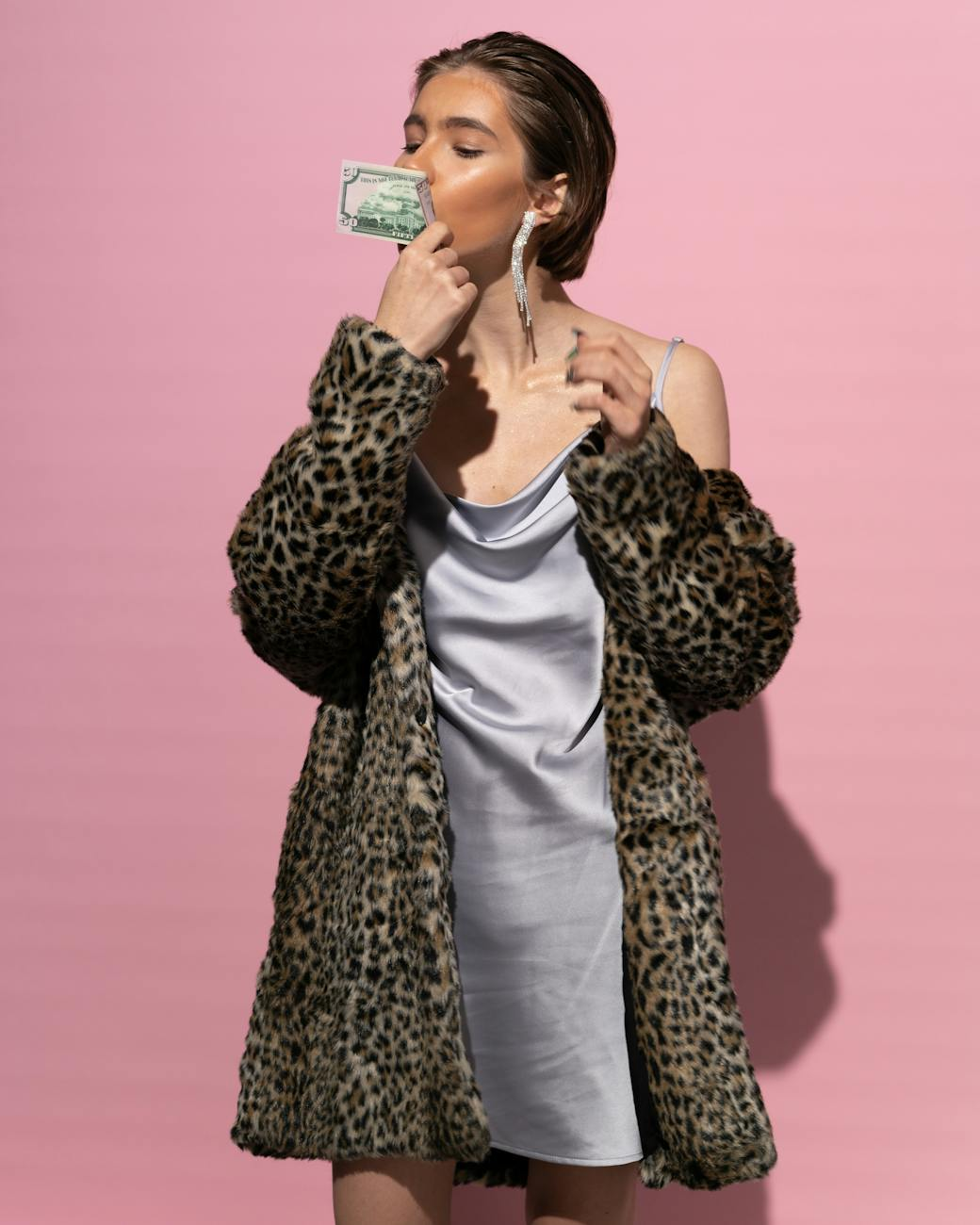 pretty woman kissing a dollar bill