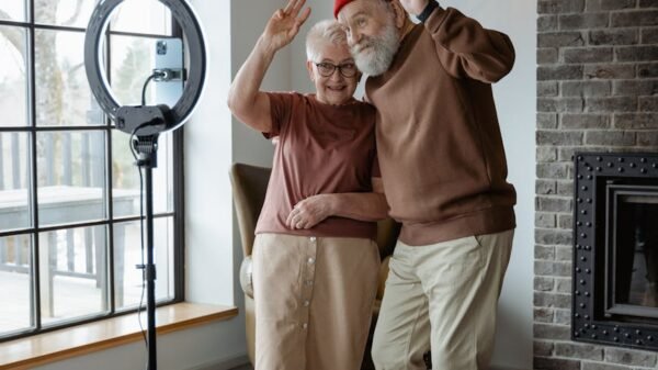 man and woman standing in front of a mobile phone