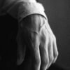left hand of a man in grayscale photography