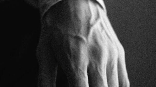 left hand of a man in grayscale photography
