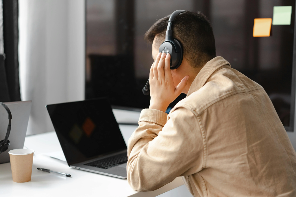 Person wearing a headset and working on a laptop during the $100 start launch process.