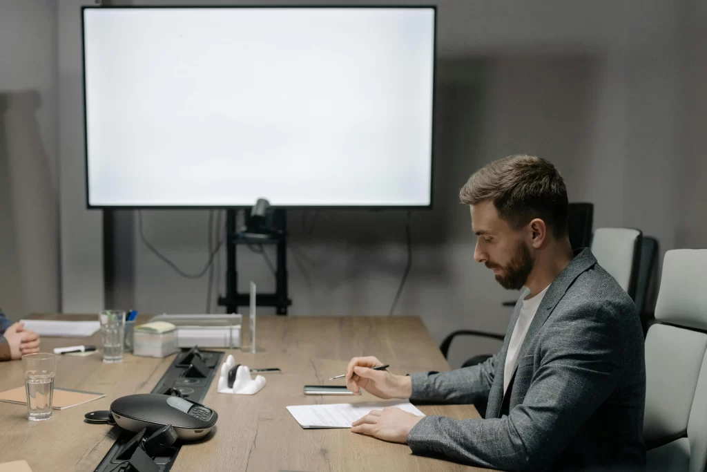 Professional man reviewing documents in a conference room, symbolizing the strategic shift fueling the rise of over-40 creators.