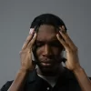 Man holding his head with both hands while experiencing stress