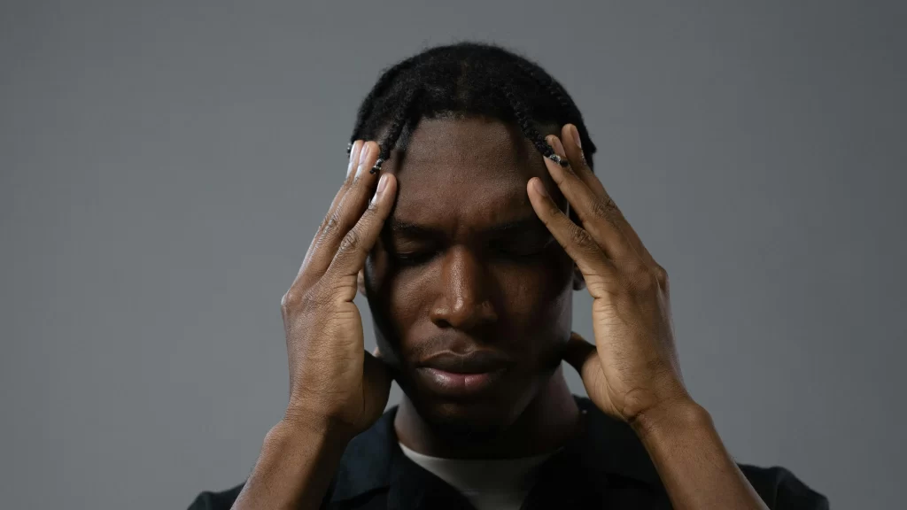 Man holding his head with both hands while experiencing stress