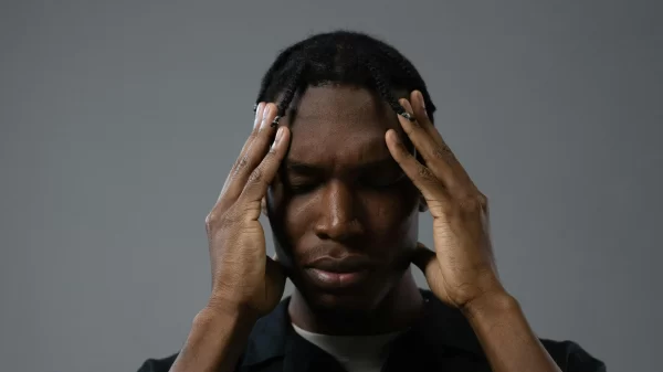 Man holding his head with both hands while experiencing stress