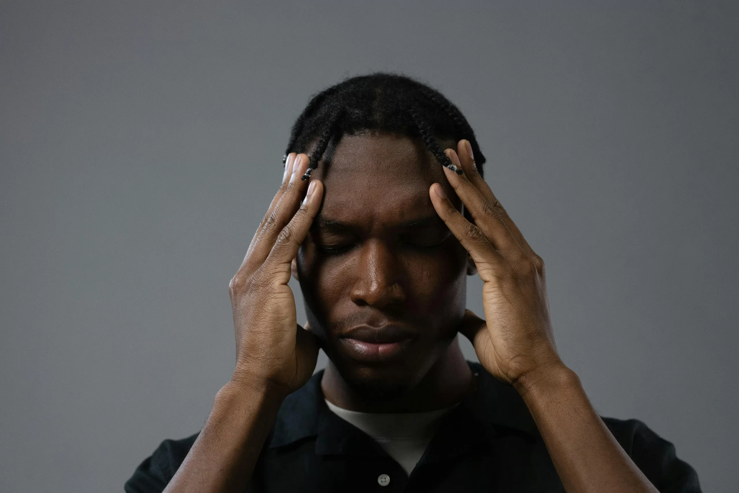 Man holding his head with both hands while experiencing stress