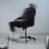 Blurred person leaning back in an office chair, symbolizing confusion and mental fog in a midlife brain reset.