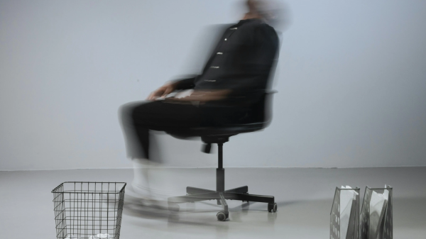 Blurred person leaning back in an office chair, symbolizing confusion and mental fog in a midlife brain reset.