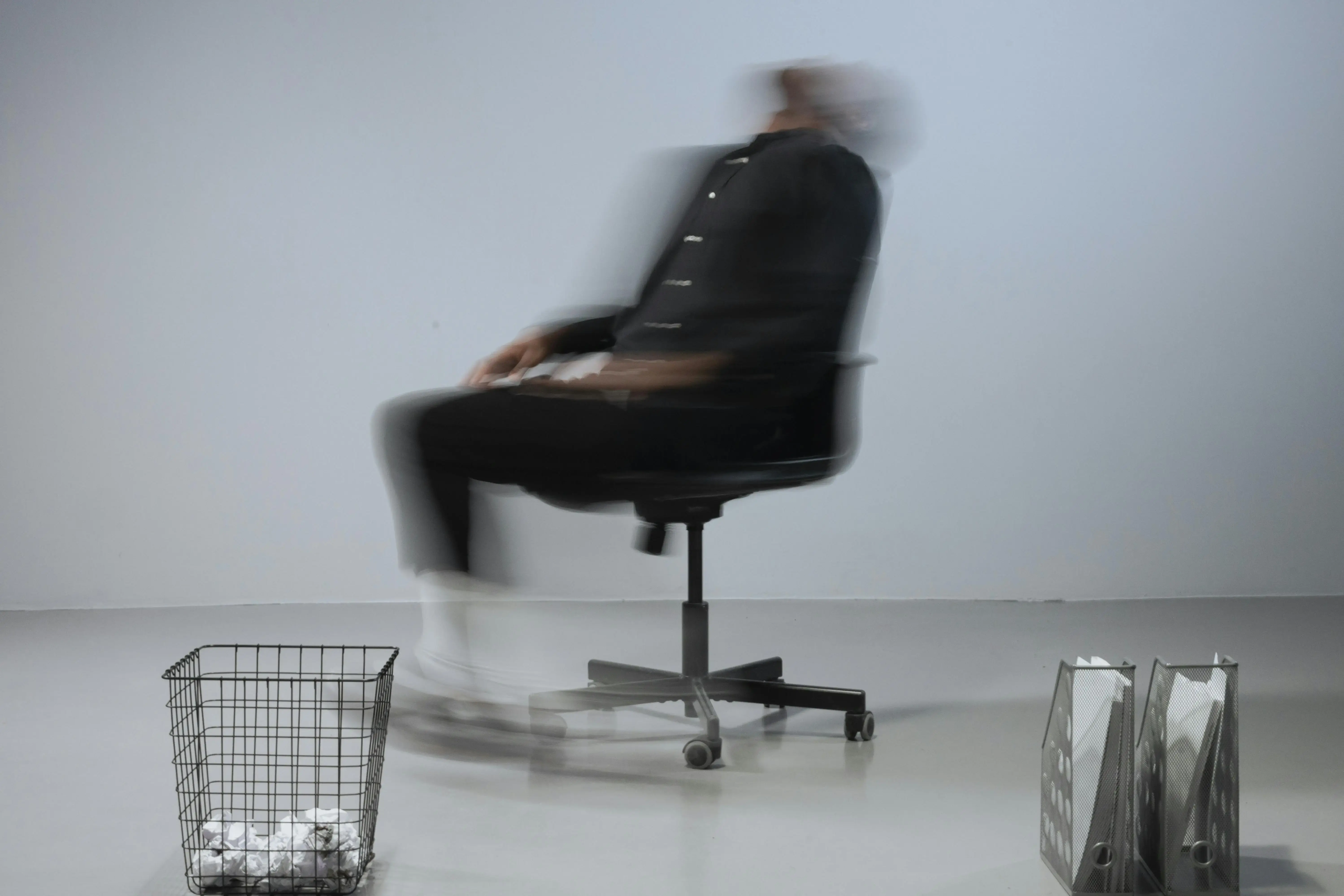 Blurred person leaning back in an office chair, symbolizing confusion and mental fog in a midlife brain reset.