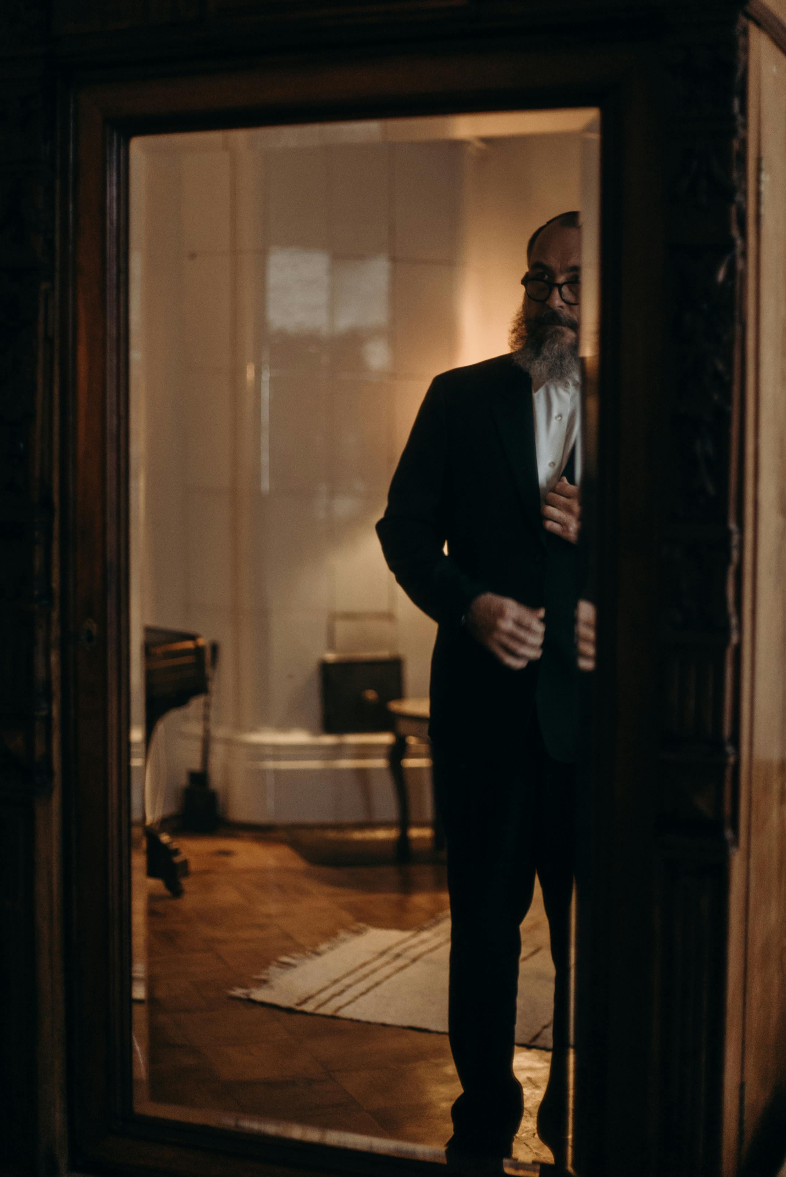Reflection of an older man in a mirror, illustrating midlife health and self-reflection