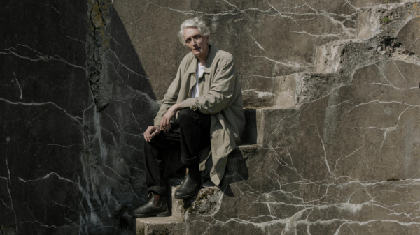 Older man sitting alone on stone steps, quietly reflecting on relationships and life transitions
