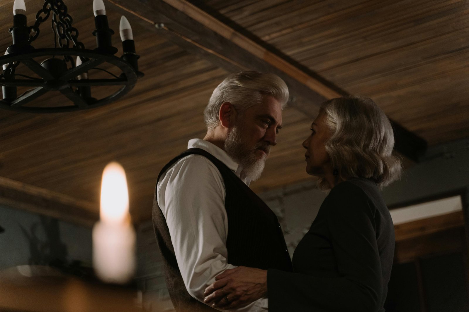 Older couple embracing indoors, showing emotional intimacy and connection after 40