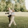 Mature couple walking outdoors carrying yoga mats during a relaxed fitness routine