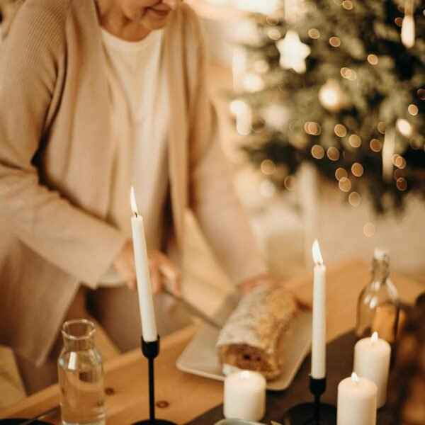Older woman preparing a cozy candlelit meal at home, embracing simple traditions and a slower pace of life