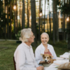 Older couple sitting at an outdoor table with their dog, enjoying a relaxed moment of connection and companionship