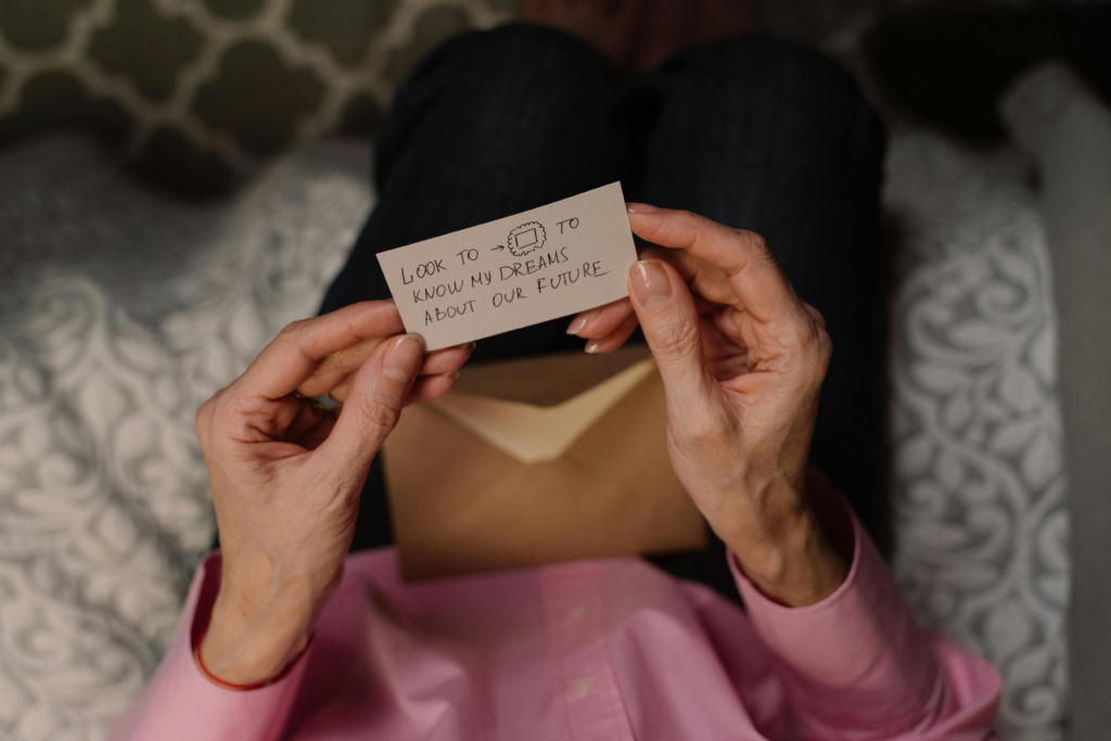 Woman holding a handwritten note about dreams and the future, reflecting on life changes