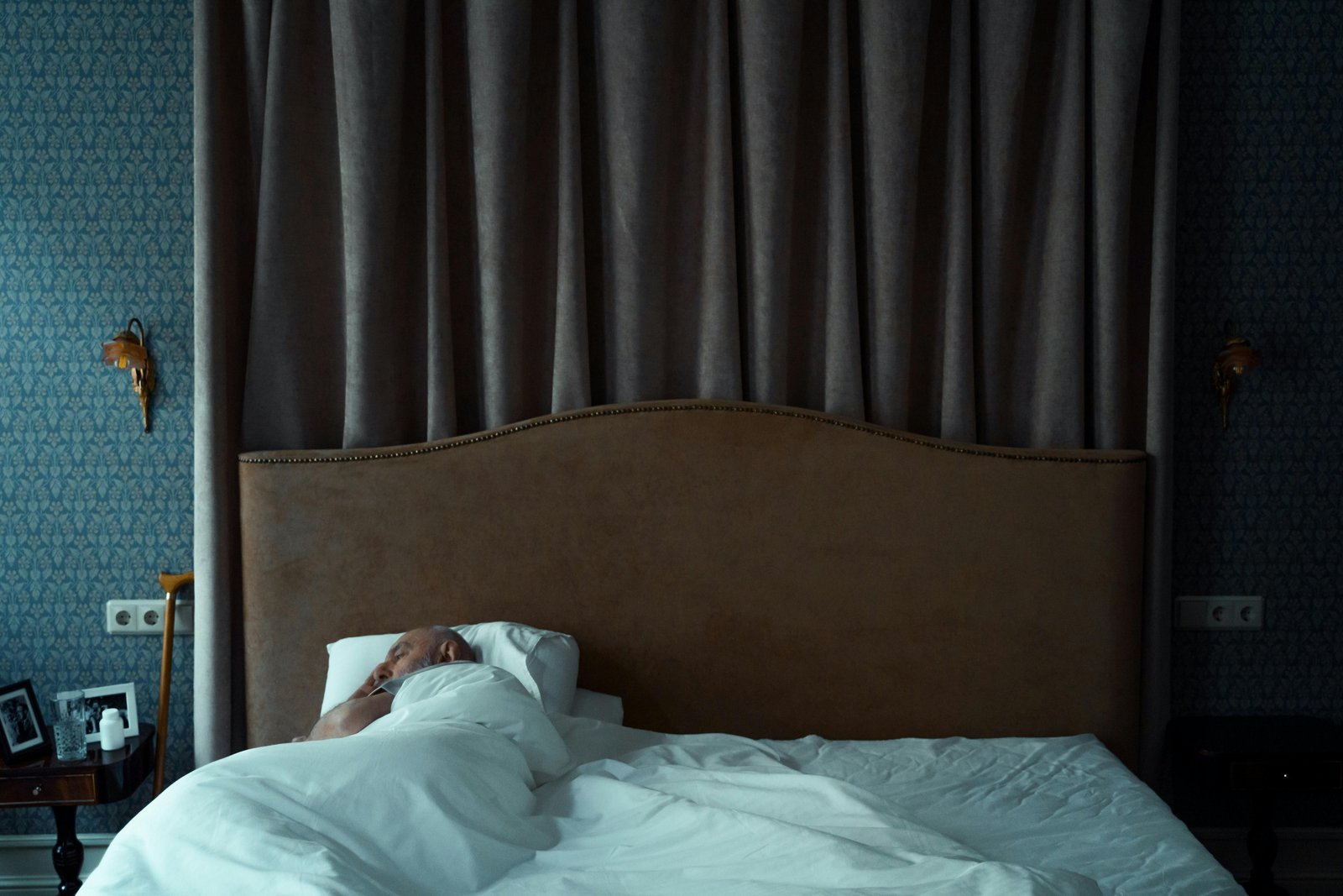 Older man lying awake in bed alone, experiencing a moment of stillness and inner quiet