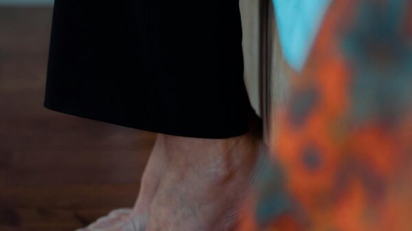 Bare feet standing on a wooden floor, symbolizing grounding, presence, and emotional connection to the body