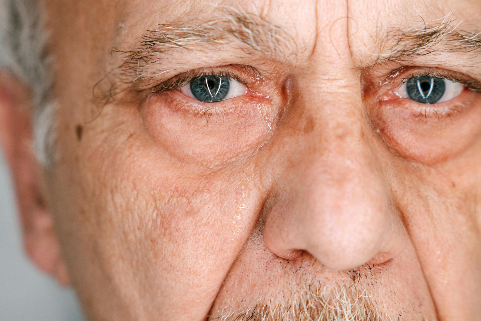 Close-up of older man’s eyes showing emotion, vulnerability, and deep reflection