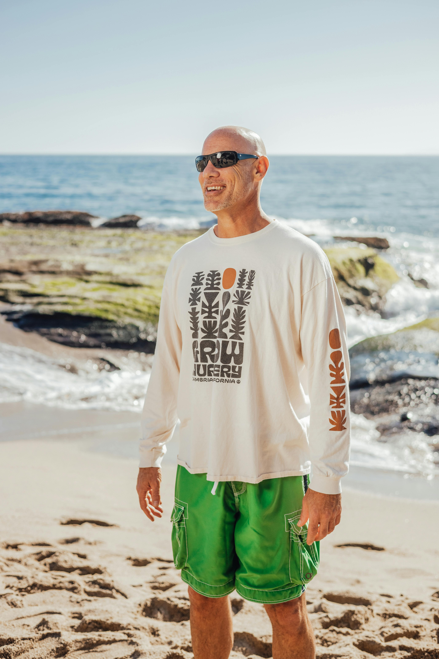 Middle-aged man enjoying a beach walk as part of an adaptive health routine