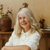 Older woman smiling calmly while reflecting during a period of personal growth and reinvention