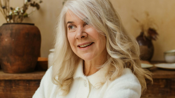 Older woman smiling calmly while reflecting during a period of personal growth and reinvention