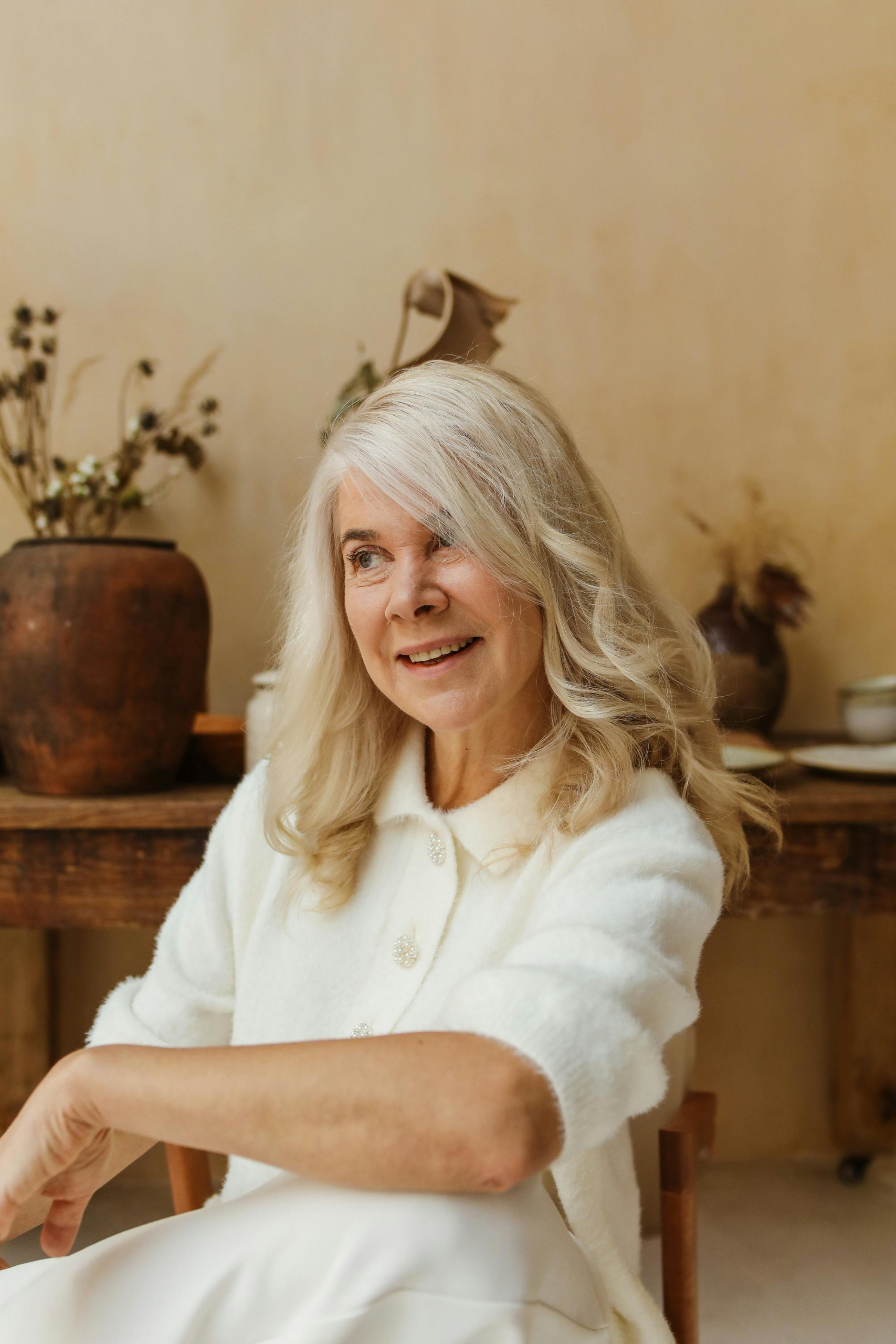 Older woman smiling calmly while reflecting during a period of personal growth and reinvention