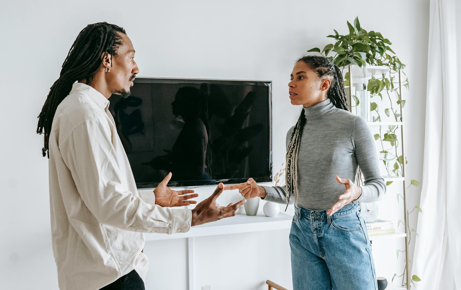 dissatisfied young ethnic couple having argument at home